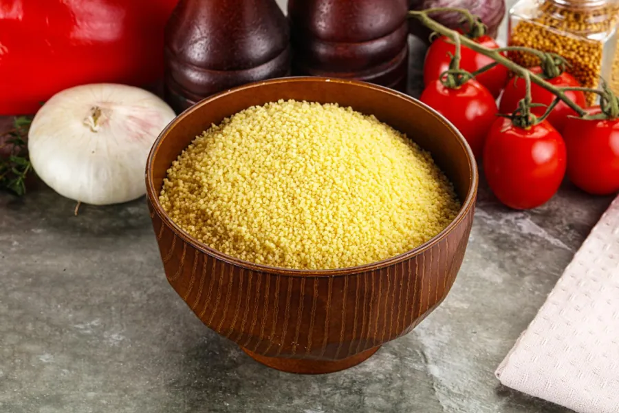 Couscous on a traditional plate with its light and fluffy pearl texture